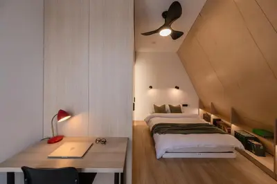 a bedroom with a bed and a desk with a lamp at Designer Penthouse with Huge Terrace & Fast Wi-Fi in Kaunas