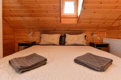 a bedroom with a bed with two towels on it at Žuvienės Pašiūrė in Rubikiai
