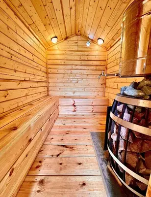 a wooden interior of a sauna with a wooden floor at Sodyba Pušyno kelias