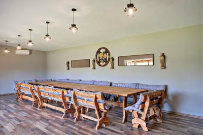 a conference room with a wooden table and chairs at Sodyba Pušyno kelias