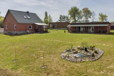 a large yard with a house and a building at Sodyba Pušyno kelias