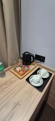 a table with two white plates and a camera on it at Private Room - Hotel Building in Vilnius