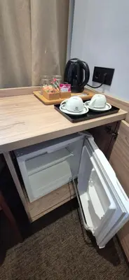 an open refrigerator with two plates on a table at Private Room - Hotel Building in Vilnius