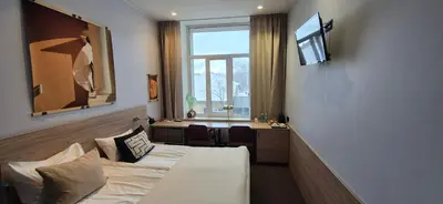 a hotel room with a bed and a desk at Private Room - Hotel Building in Vilnius