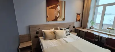 a bedroom with a bed with pillows and a mirror at Private Room - Hotel Building in Vilnius