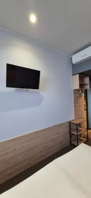 a white wall with a flat screen tv on it at Private Room - Hotel Building in Vilnius