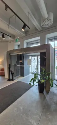 a lobby with a plant in the middle of a room at Private Room - Hotel Building in Vilnius