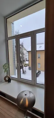 a window with a view of a snow covered yard at Cozy Private Room in Corner Building in Vilnius