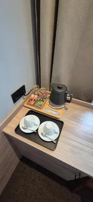 a table with two plates and a pot on it at Private Double Room in Corner Building in Vilnius
