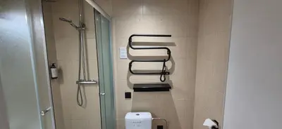 a bathroom with a shower and a toilet at Private Double Room in Corner Building in Vilnius