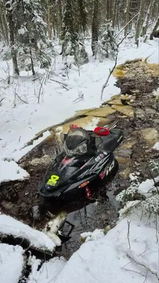 a snowmobile laying on the ground in the snow at Atgal i gamta in Ukmergė