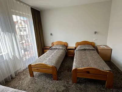 three beds in a room with a window at Keta in Marijampolė