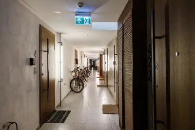 a long hallway with bikes parked on the walls at Cozy Top-Floor Apartment with City Views Vilnius in Vilnius