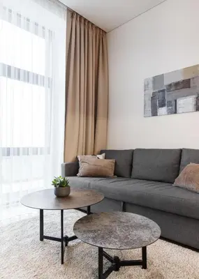 a living room with a couch and a table at Cozy Top-Floor Apartment with City Views Vilnius in Vilnius