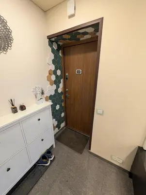 a bathroom with a wooden door and a cabinet at Jaukūs apartamentai prie Šiaulių arenos in Šiauliai
