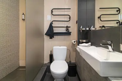 a bathroom with a white toilet and a sink at Hotel Premium Rooms in Vilnius