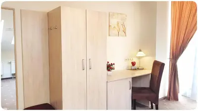 a room with a desk and a cupboard at HOME Studios & Apartments Old town 10 min walk 24-hours Front desk Vilnius in Vilnius