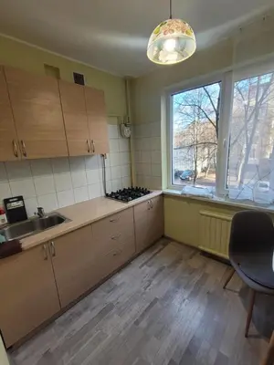 an empty kitchen with a sink and a window at Šiaurės Butas in Kaunas