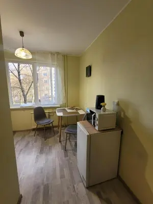an office with a desk and chairs and a table and a window at Šiaurės Butas in Kaunas