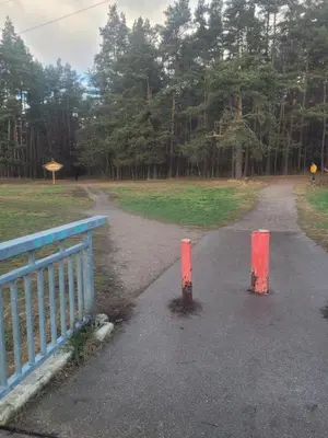 a road with two red posts in the middle at Šiaurės Butas in Kaunas