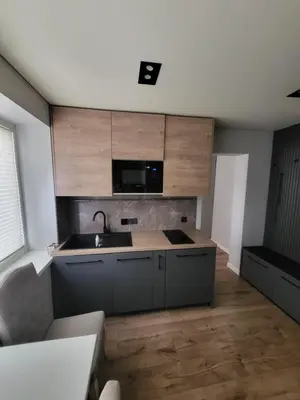 a kitchen with a sink and a microwave at Ekonomiskas in Vilnius