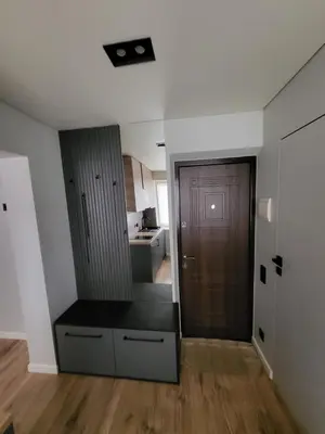 an empty apartment with a door and a kitchen at Ekonomiskas in Vilnius