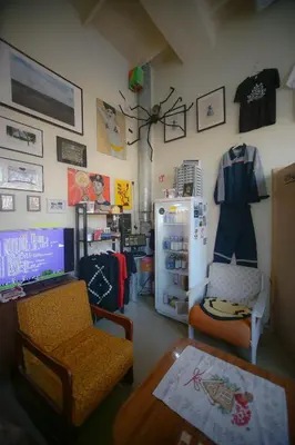 a room with a refrigerator and a chair and a table at Micro Art Residence & Party Event Venue in Vilnius