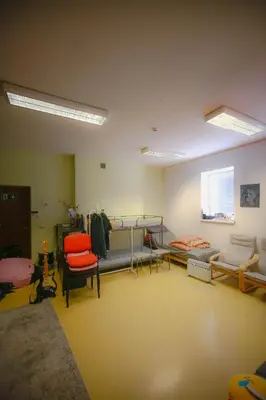 a room with several bunk beds and chairs in it at Micro Art Residence & Party Event Venue in Vilnius