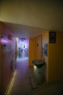 a hallway with a trash can in a room at Micro Art Residence & Party Event Venue in Vilnius