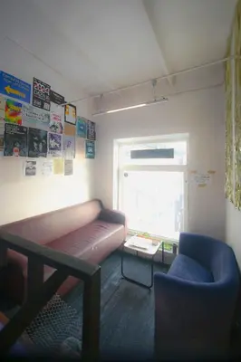 a room with a couch and a table and a window at Micro Art Residence & Party Event Venue in Vilnius