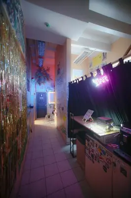 a room with a table and a purple curtain at Micro Art Residence & Party Event Venue in Vilnius