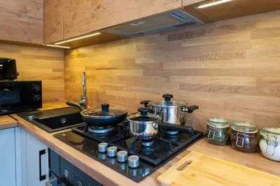 a kitchen with two pots and pans on a stove at City Essetials Apartmets in Kaunas
