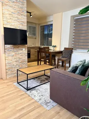 a living room with a couch and a table at Premium 1-Bedroom Apartment in Vilnius Center with Self Check-in in Vilnius