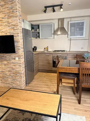 a kitchen with a table and a dining room at Premium 1-Bedroom Apartment in Vilnius Center with Self Check-in in Vilnius
