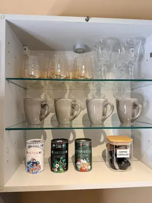 a shelf filled with glasses and other glass items at Premium 1-Bedroom Apartment in Vilnius Center with Self Check-in in Vilnius