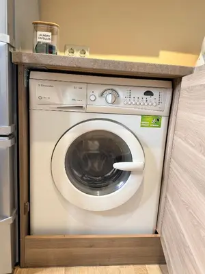 a washing machine in a kitchen with a counter at Premium 1-Bedroom Apartment in Vilnius Center with Self Check-in in Vilnius