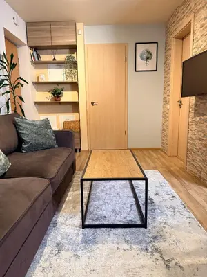 a living room with a couch and a coffee table at Premium 1-Bedroom Apartment in Vilnius Center with Self Check-in in Vilnius