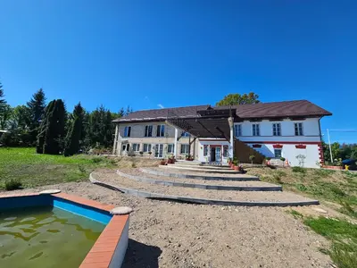 a house with a swimming pool in front of it at Šaltenių pašvaistė