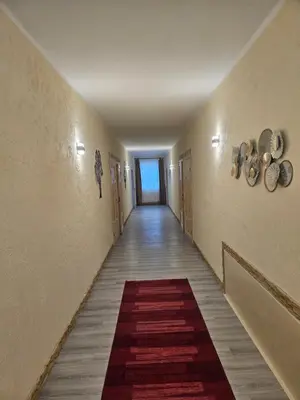 a long hallway with a red rug on the floor at Šaltenių pašvaistė