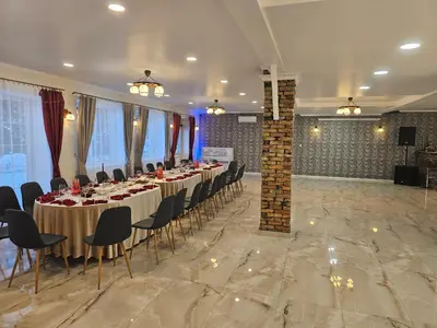 a banquet hall with tables and chairs in a room at Šaltenių pašvaistė