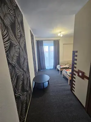 a room with a room with a table and a bed at Šaltenių pašvaistė