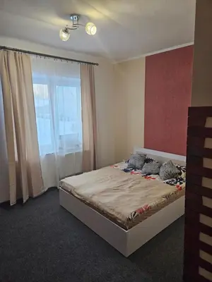 a bedroom with a large bed with a window at Šaltenių pašvaistė