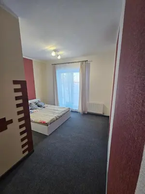 an empty room with a bed and a window at Šaltenių pašvaistė