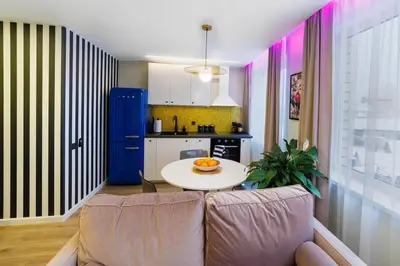 a living room with a couch and a table at Stilinga studija su visais patogumais in Šiauliai