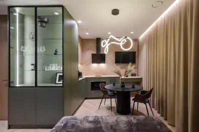 a room with a table and chairs and a kitchen at Cozy studio apartment in Kaunas