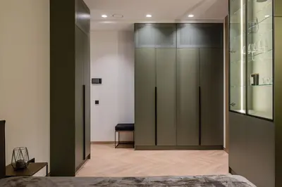 a bedroom with sliding glass doors in a room at Cozy studio apartment in Kaunas