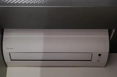 a white microwave oven sitting under a ceiling at Cozy studio apartment in Kaunas