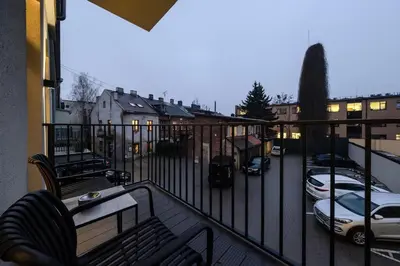 a balcony with a view of a parking lot with cars at Cozy studio apartment in Kaunas