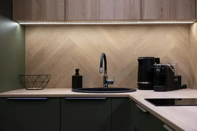 a kitchen counter with a sink and a coffee maker at Cozy studio apartment in Kaunas