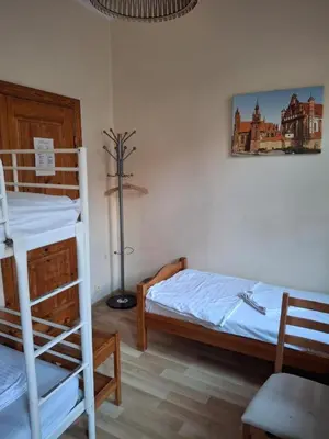 a bedroom with two bunk beds and a lamp at Litinterp Host in Vilnius